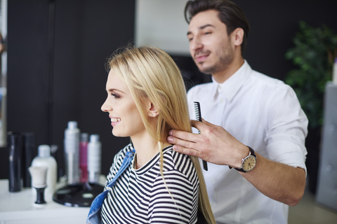 Smiling woman at the hairdresser stock photo