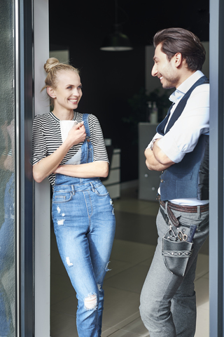 Two smiling hairdressers taking a break in hair salon stock photo