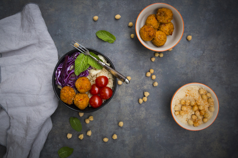 Couscous sweet potato falafel bowl with red cabbage, tomato, mint and hummus stock photo