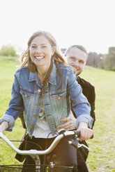 Happy couple riding bicycle - MASF06898