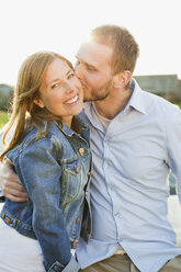 Man kissing woman on cheek - MASF06905