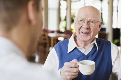 Elderly man drinking coffee stock photo
