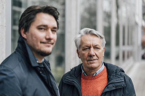 Portrait of young man and senior man in the city stock photo