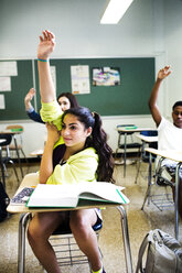 Students raising hands during lesson in classroom - CAVF48518