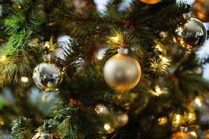 Close-up of ornaments and lights on Christmas tree - CAVF48621