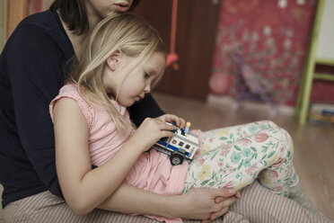 Mother and daughter, playing with toy car - KMKF00233