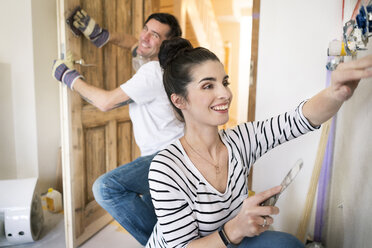 Happy couple renovating new home - PESF01055