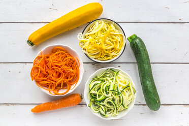 Zoodles, green and yellow zucchini, carrot on white wood - SARF03673