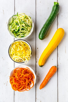 Zoodles, green and yellow zucchini, carrot on white wood - SARF03676