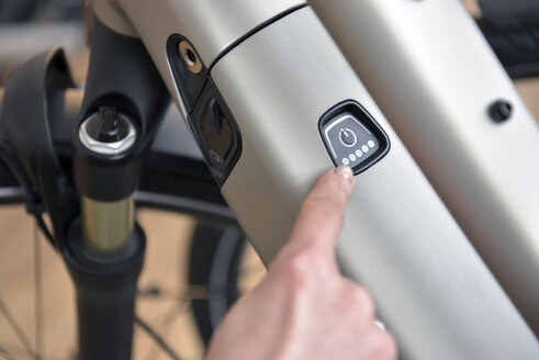 Fingerzeig auf den Schalter eines E-Bikes - LYF00840