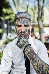 Young businessman with tattooed face, looking at camera - ZEDF01349