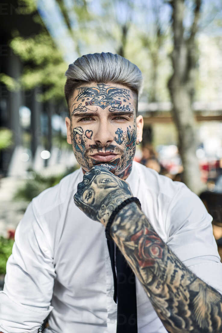 Businessman revealing hidden tattoo Stock Photo by ©innovatedcaptures  49320993