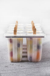 Homemade fruits and yogurt ice lollies on marble - RTBF01207