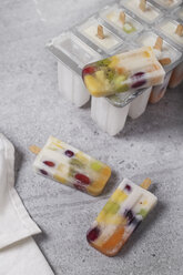 Homemade fruits and yogurt ice lollies on marble - RTBF01208