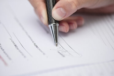 Woman signing documents - ZEF15386