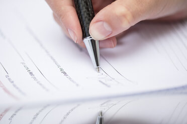 Woman signing documents - ZEF15387