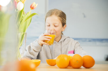 Portrait of girl drinking glass of orange juice - NEKF00032