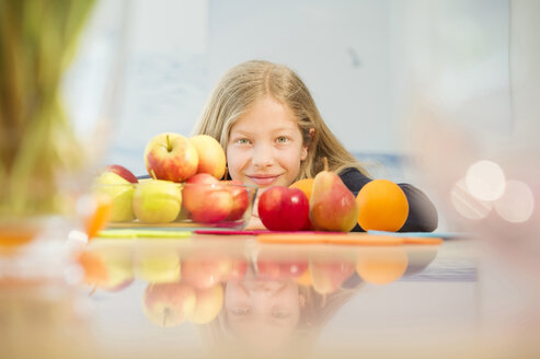 Porträt eines lächelnden Mädchens mit verschiedenen Früchten - NEKF00034