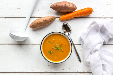 Bowl of sweet potato carrot soup garnished with cress - SARF03681