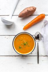 Bowl of sweet potato carrot soup garnished with cress - SARF03682