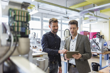 Two businessmen with tablet talking in factory - DIGF03969