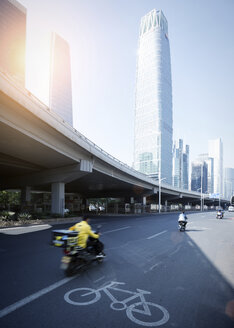 China, Beijing, High-rise building and traffic on road - SPPF00023
