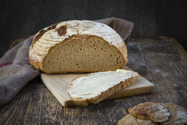 Homemade sourgough rye bread on chopping board - LVF06911
