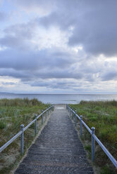 Germany, Ruegen Island, Binz, Baltic Sea, wooden boardwalk to beach in the evening - RUEF01868