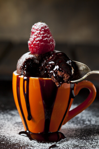 Schokoladenkuchen mit Puderzucker, Schokoladensauce und Himbeeren, lizenzfreies Stockfoto