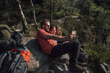 Germany, Saxony, Elbe Sandstone Mountains, friends on a hiking trip having a break taking a selfie - GUSF00730