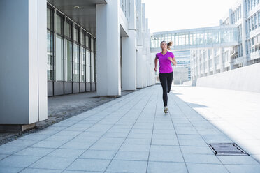 Young woman running in the city - DIGF04050