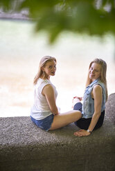 Two friends relaxing together on a wall - BEF00006