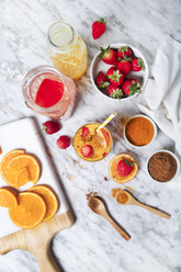 Strawberry and orange smoothie with curcuma and cinnamon on marble - RTBF01239