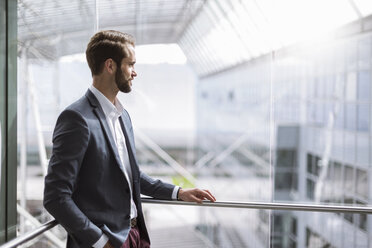 Young businessman standing at railing - DIGF04092