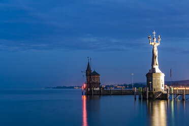 Germany, Constance, view to port entrance with lighthouse and Imperia at twilight - WDF04646