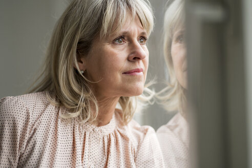 Mature woman looking out of window - HHLMF00292