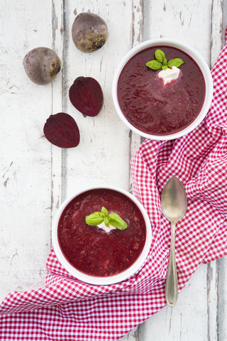 Beetroot soup in bowl on white wood stock photo