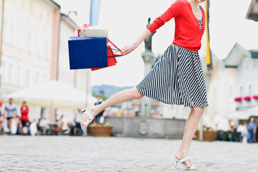 Woman runs through a shopping street - CUF00269