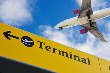 Plane flying over 'terminal' sign - CUF00488