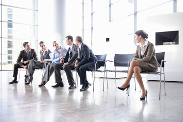 Woman sitting alone separate from group - CUF00509