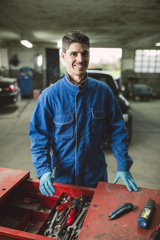 Portrait of smiling mechanic in his workshop stock photo