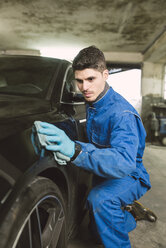 Man cleaning a car in a workshop - RAEF01997