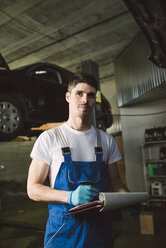 Mechanic with clipboard and checklist in his workshop - RAEF02021