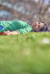 Portrait of happy young woman lying on meadow - BEF00025