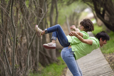 Happy mother and daughter having fun on boardwalk - JSMF00192