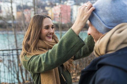 Portrait of happy young woman having fun with her boyfriend at winter time stock photo