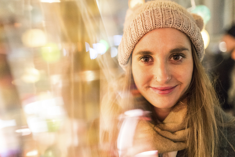Portrait of smiling young woman at Christmas market stock photo
