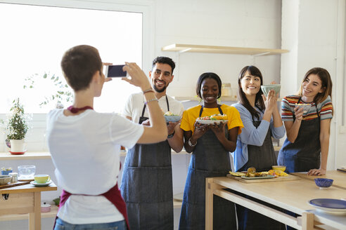 Instructor taking a picture of friends in a cooking workshop - EBSF02463