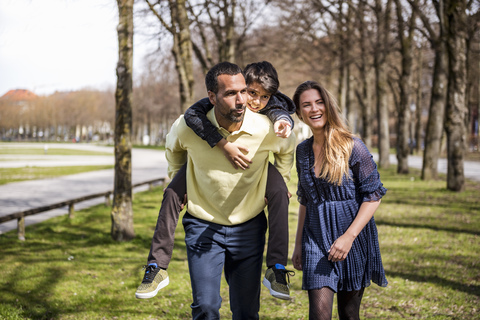 Happy family walking in a park stock photo