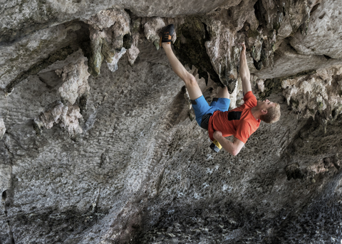 Thailand, Krabi, Lao liang island, man bouldering in rock wall stock photo